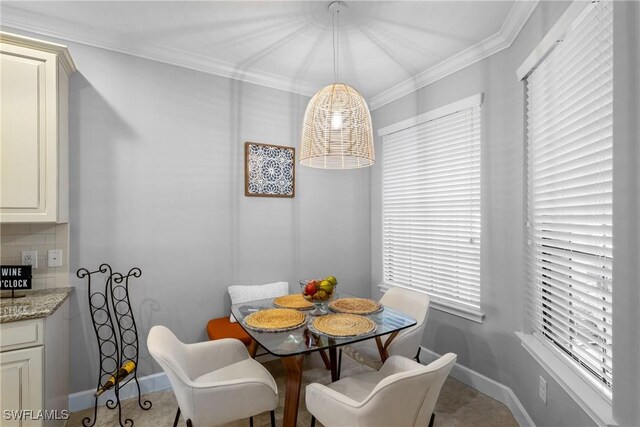 dining area featuring baseboards and crown molding