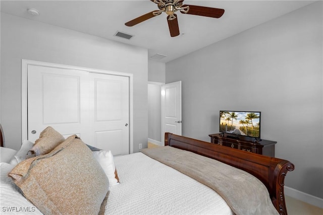 bedroom with a closet, baseboards, and ceiling fan