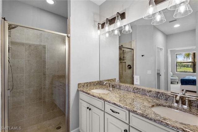 bathroom featuring a stall shower, double vanity, and connected bathroom