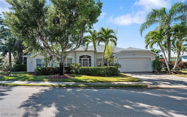 single story home featuring a garage and a front lawn