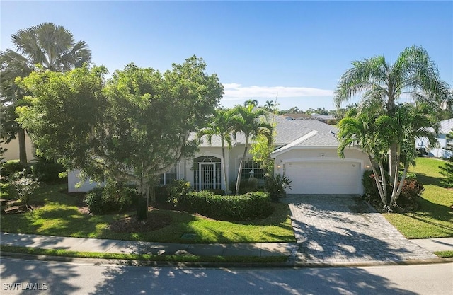 view of front of property with a garage and a front yard