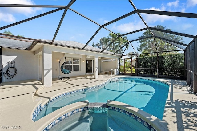 view of swimming pool with an in ground hot tub, a lanai, and a patio area