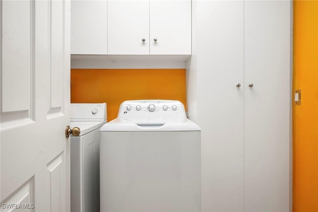 laundry room featuring cabinets and separate washer and dryer