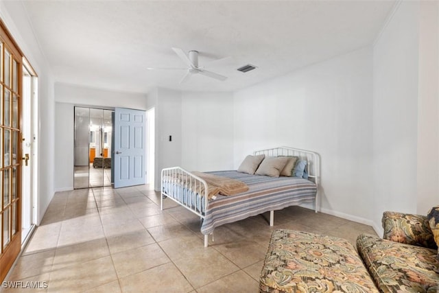 bedroom with ceiling fan and light tile patterned flooring