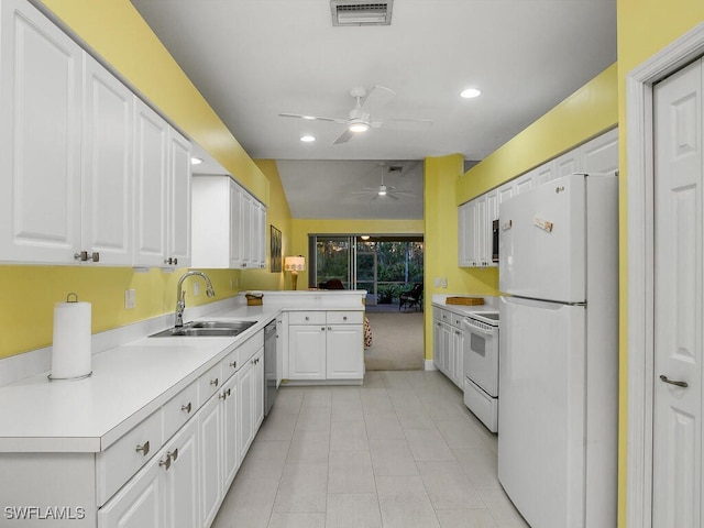 kitchen featuring white cabinetry, white appliances, kitchen peninsula, and sink