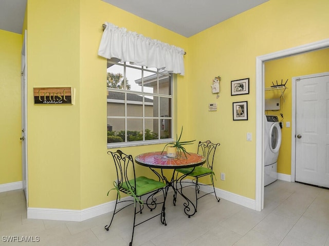 dining area featuring washer / dryer and light tile patterned floors