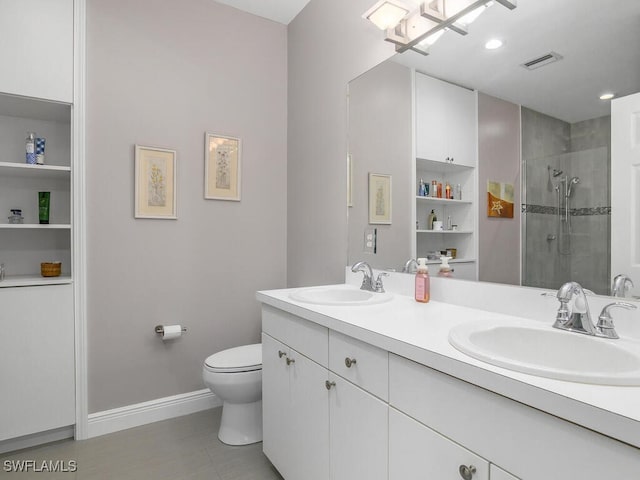 bathroom with vanity, a shower with door, and toilet