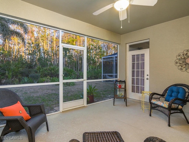 sunroom / solarium featuring ceiling fan