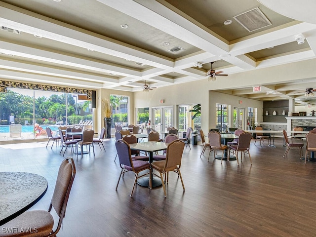 dining room with dark hardwood / wood-style floors, beamed ceiling, coffered ceiling, ceiling fan, and french doors