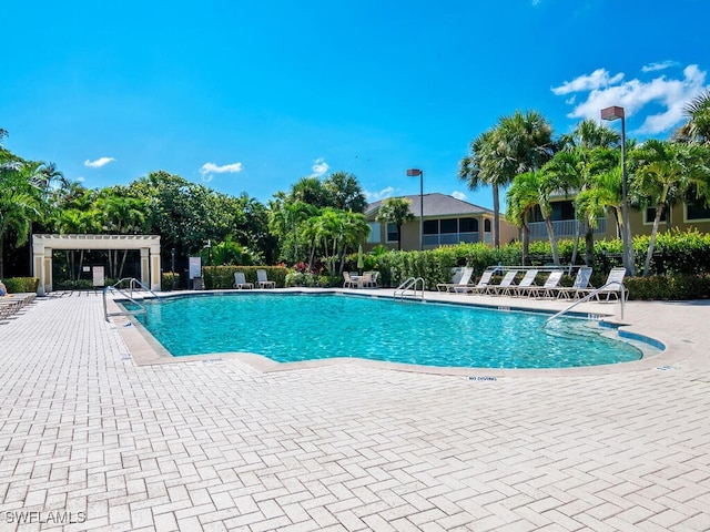 view of pool with a pergola and a patio area