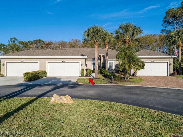 ranch-style home featuring a garage and a front yard