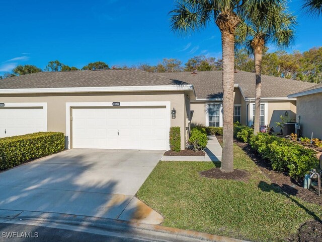 23252 Grassy Pine Dr, Estero, FL 33928 - ranch-style house featuring a garage and central air condition unit