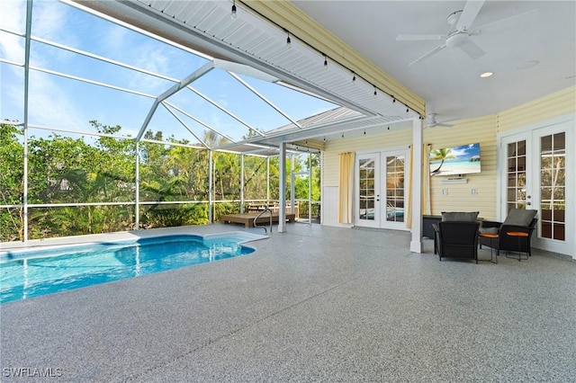 pool featuring a lanai, a patio area, ceiling fan, and french doors