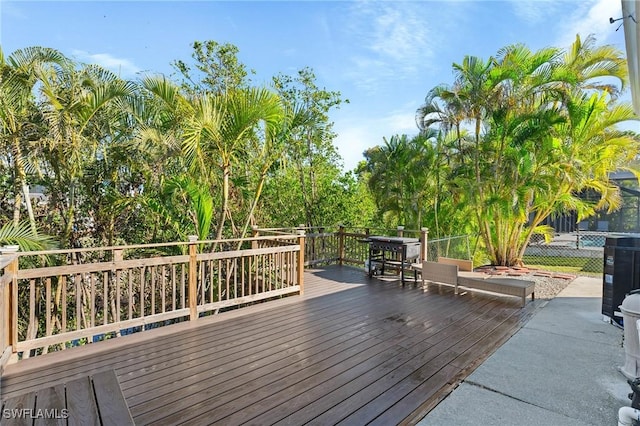 wooden terrace featuring fence