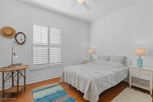 bedroom with baseboards, dark wood finished floors, and a ceiling fan