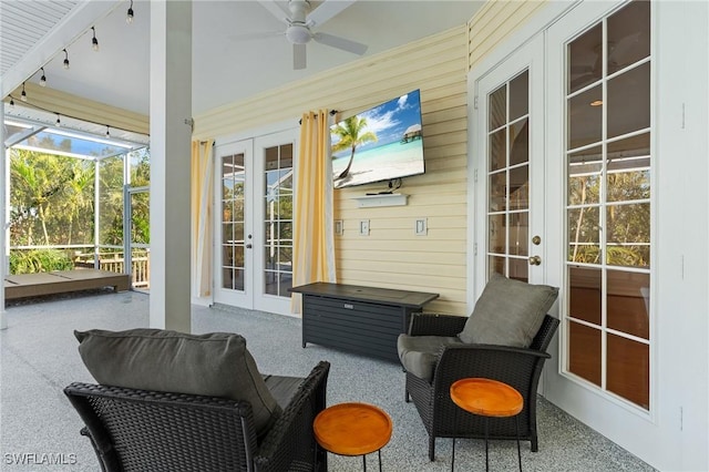 sunroom with rail lighting, a ceiling fan, and french doors