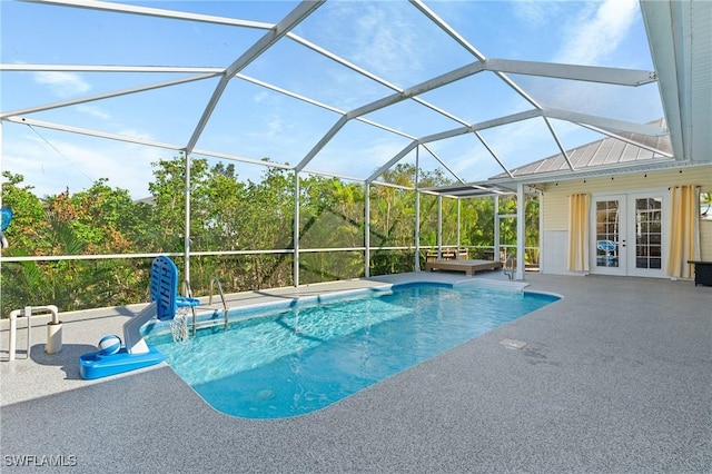 outdoor pool with glass enclosure, a patio area, and french doors