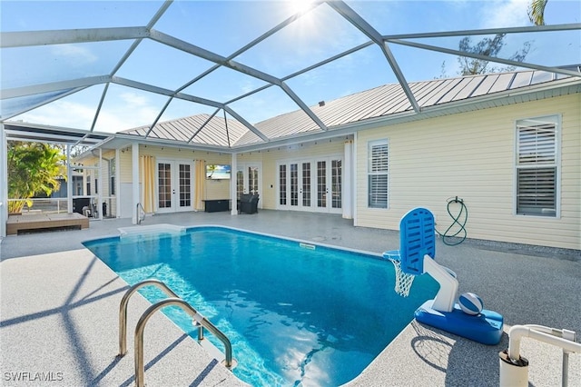 outdoor pool featuring french doors, a patio, and a lanai