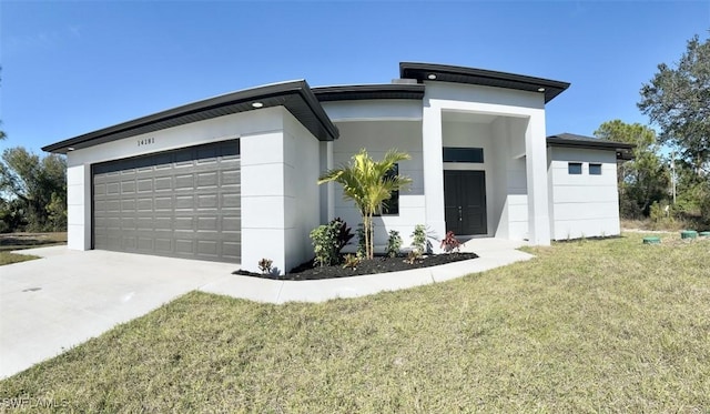 view of front of property featuring a garage and a front yard