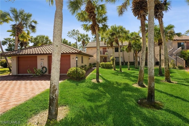 exterior space with a garage and a front lawn