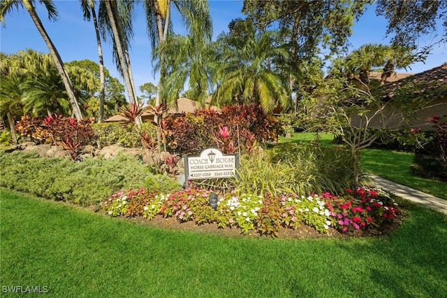 community / neighborhood sign with a yard