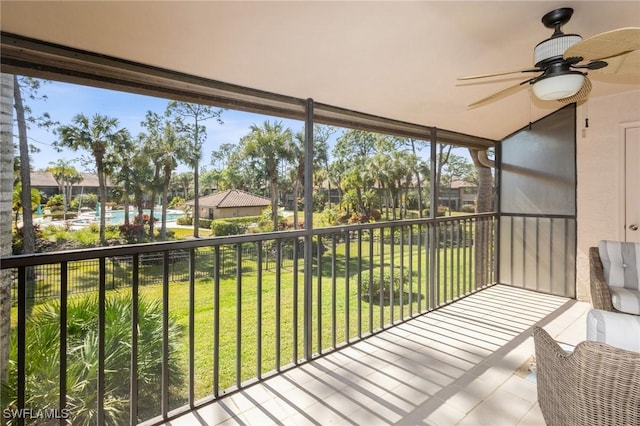 unfurnished sunroom with ceiling fan