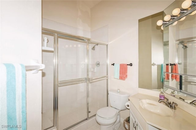 bathroom featuring vanity, toilet, and a shower with shower door