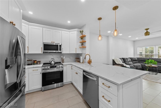 kitchen featuring appliances with stainless steel finishes, sink, white cabinets, and kitchen peninsula