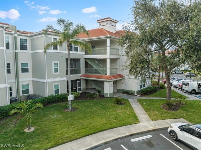 23710 Walden Center Dr Unit 210, Estero, FL 34134 - view of property with uncovered parking and stairs