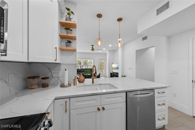 kitchen with stainless steel appliances, a sink, visible vents, white cabinets, and backsplash