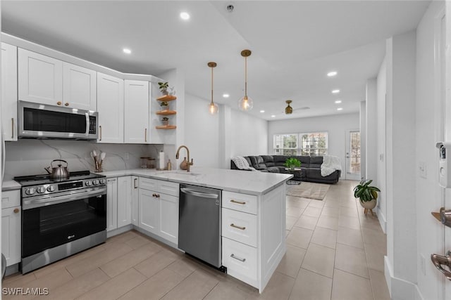 23710 Walden Center Dr Unit 210, Estero, FL 34134 - kitchen featuring stainless steel appliances, a sink, a peninsula, recessed lighting, and a ceiling fan