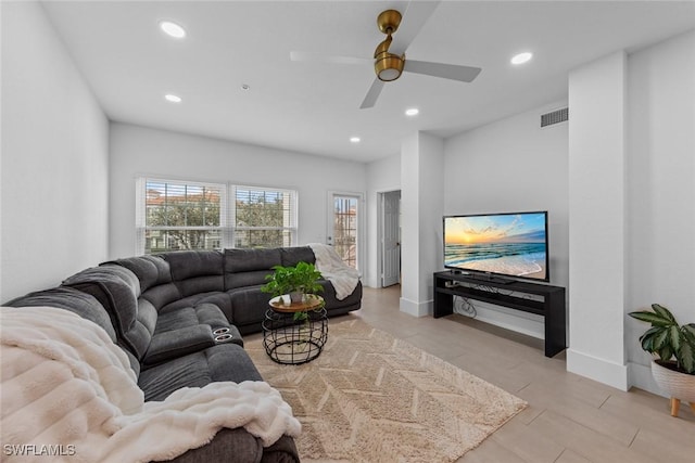 living room with recessed lighting, visible vents, and baseboards