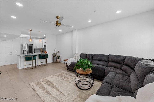 living area featuring a ceiling fan and recessed lighting