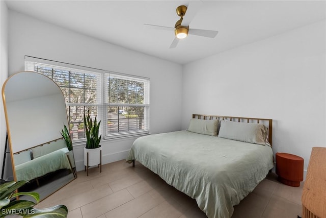 tiled bedroom with multiple windows and ceiling fan