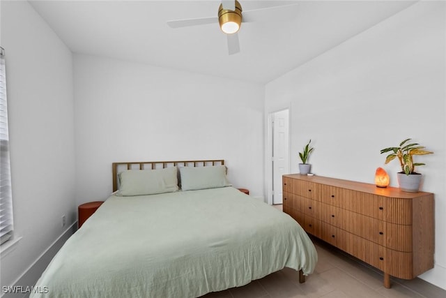 bedroom with ceiling fan and light tile patterned floors