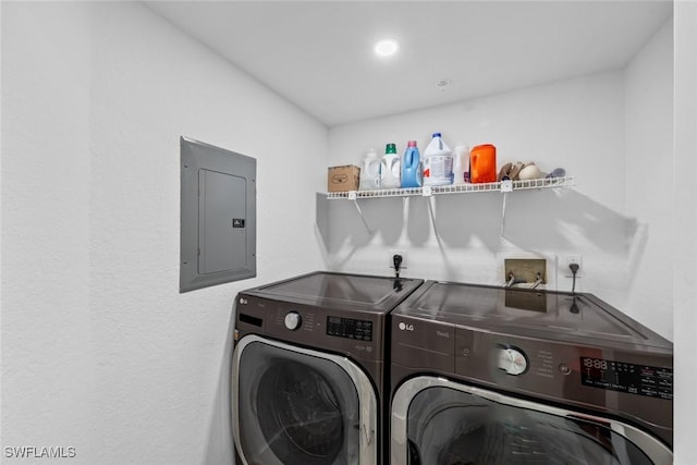 washroom featuring washer and clothes dryer and electric panel