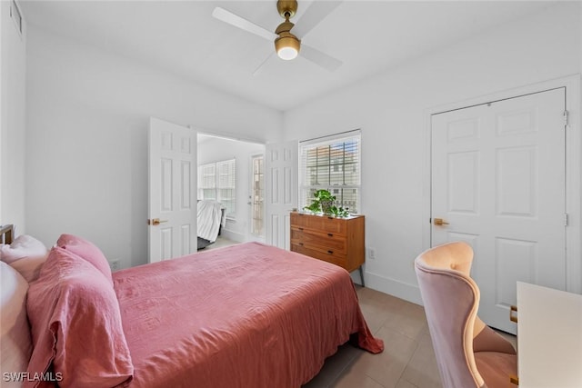 bedroom with ceiling fan and light tile patterned floors