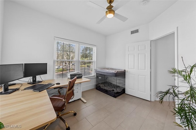 office space with ceiling fan, light tile patterned floors, and visible vents