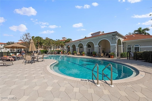 pool featuring a patio area and fence