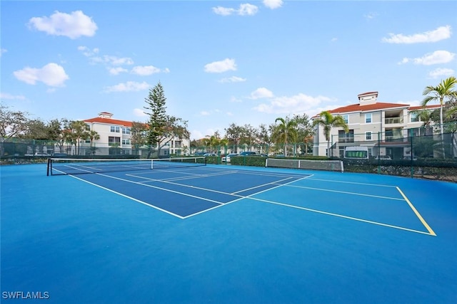 view of sport court featuring fence