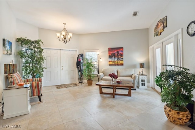 interior space with an inviting chandelier, light tile patterned floors, and a wealth of natural light