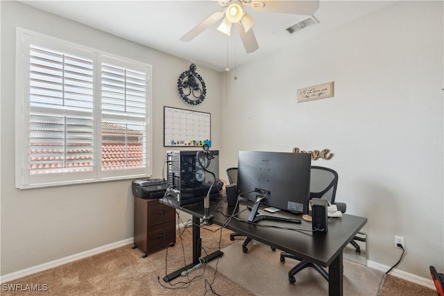 carpeted office featuring ceiling fan