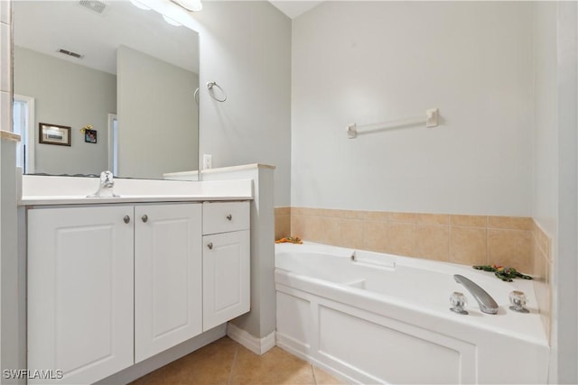 bathroom with vanity, a bathing tub, and tile patterned flooring