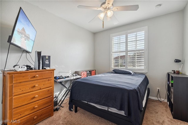 bedroom featuring light carpet and ceiling fan