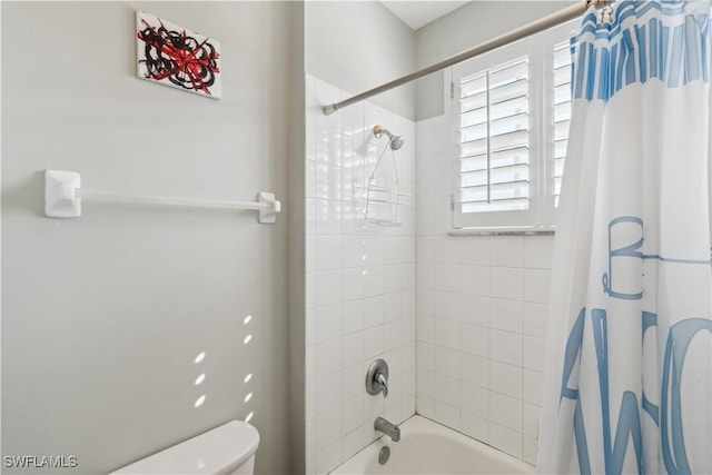 bathroom with toilet and shower / bath combo