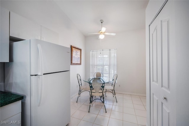 dining room with light tile patterned floors and ceiling fan