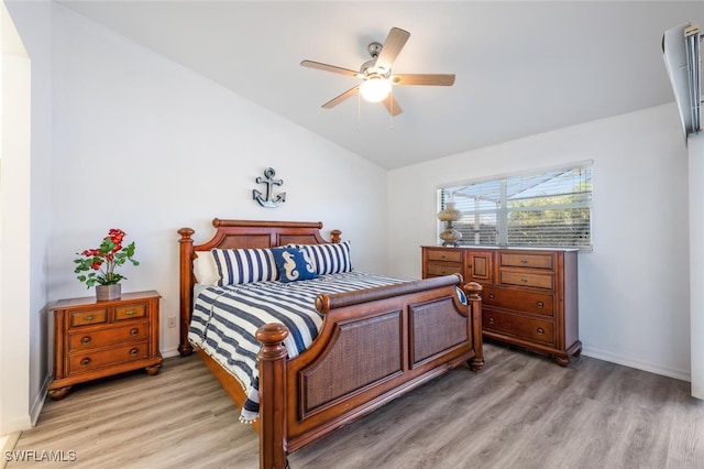 bedroom featuring ceiling fan, lofted ceiling, and wood-type flooring