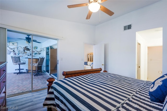 bedroom with ceiling fan, wood-type flooring, and access to outside