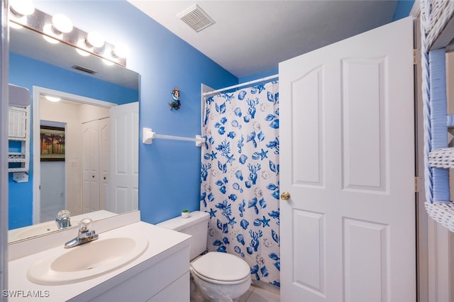 bathroom with vanity, curtained shower, and toilet