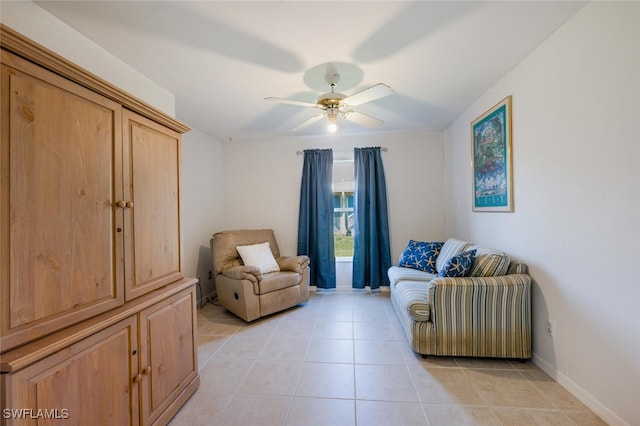 living area featuring light tile patterned flooring and ceiling fan